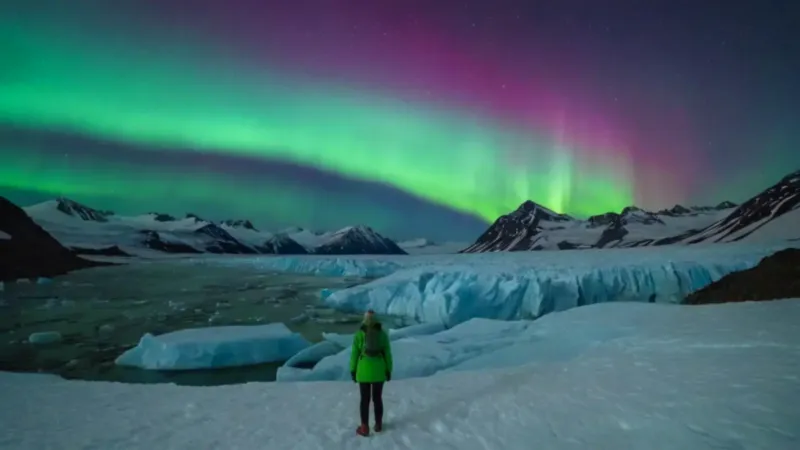 Hombre solo ante la aurora boreal